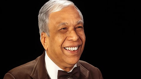 An image of Dr. Jaiveer Agarwal in a brown suit and bow tie.