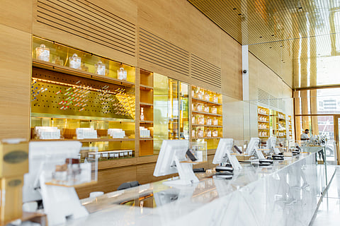 A long counter in a cannabis dispensary displaying various products and items for sale.