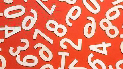 Image of numbers in white color and in front of orange color background.
