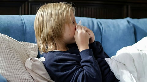 An imagde of a young child suffering from flu