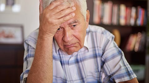 Image of an old man in depressing expression.