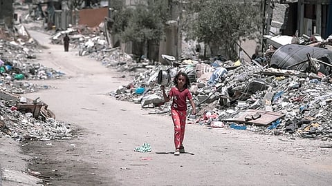 Image of a girl walking on the street of Gaza suffering from child famine.