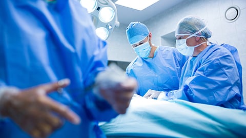 Surgeons performing an operation in an operation theatre.