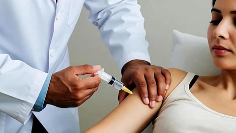 An image of a doctor putting injection on a woman.