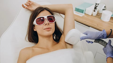 A woman is undergoing a Laser treatment for her underarms.