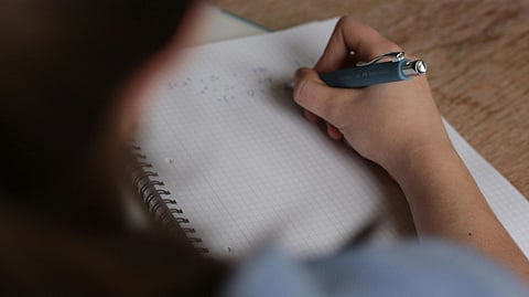 Image of a person writing an exam.