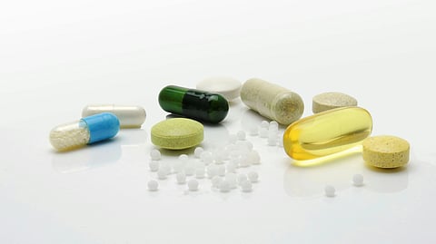 Image of different types of medicines over a white surface.