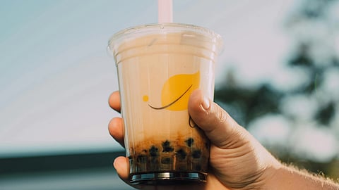 Image of a person holding a cup of bubble tea.