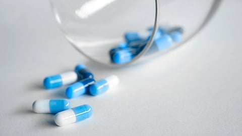 Image of blue and white capsules representing antidepressants scattered on the floor.