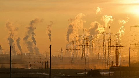 Image of an industry site scene depicting air pollution coming out from the factories.