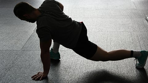 A man performing a push-up on the floor, demonstrating strength and fitness.