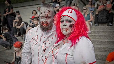 An image of 2 people dressed in zombie costumes.