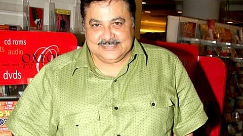 Image of Satish Shah wearing a light brown shirt and smiling.