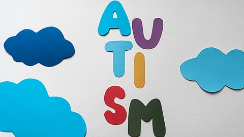 An image of cut out letters spelling AUTISM.