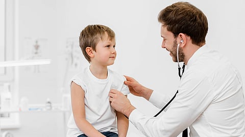 A doctor checking upon a child.