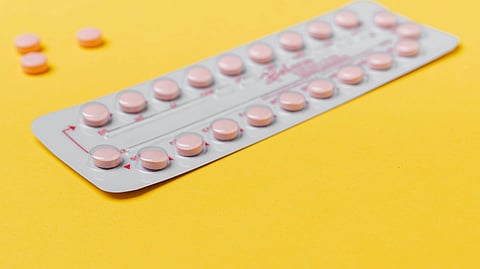 Image of a birth control strip over a yellow surface.