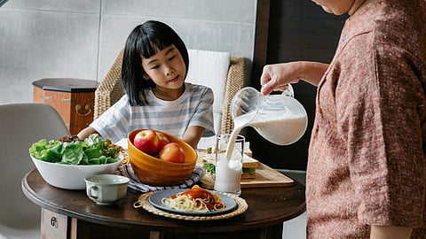 Image of a mother and daughter having breakfast together.
