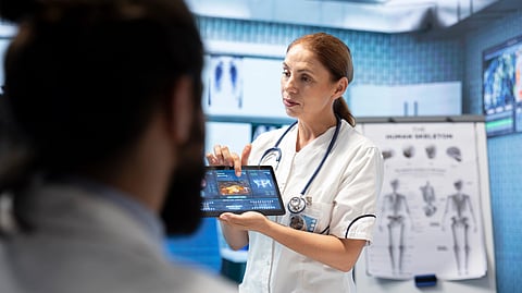 An image of a healthcare staff showing chart.