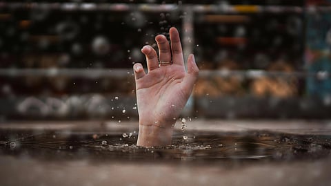 Image of a person drowning in Rough Seas off Kerala's Payyambalam Beach.