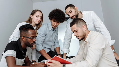 A diverse group of professionals collaborating in a modern office environment.