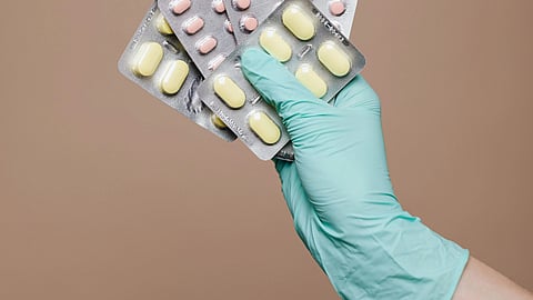 Image of a person holding strips of different tablets.