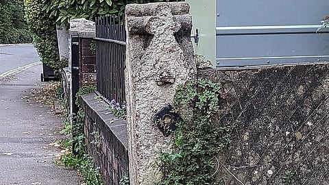 Apperance of a face on the pillar of the stone fence is visible indicating face pareidolia.