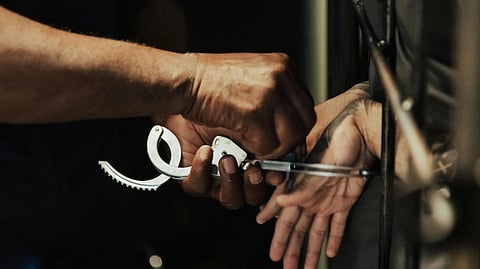 An image of a man being handcuffed.