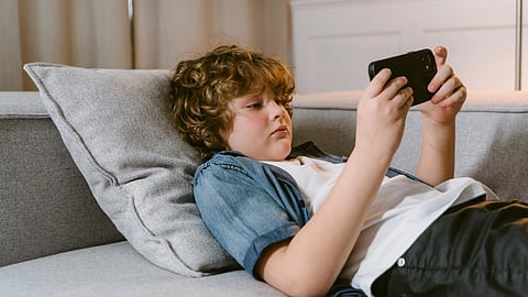 An image of a kid seeing screen.