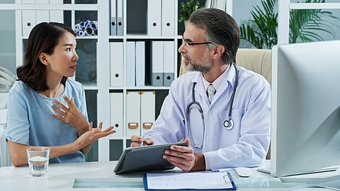 A doctor discussing health concerns with a patient in a well-lit office setting.