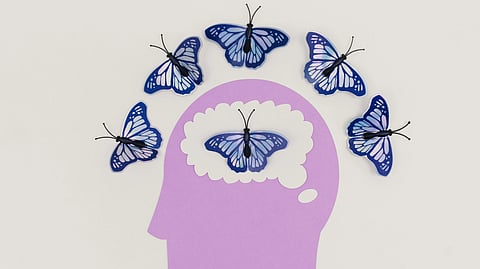 A purple head adorned with colorful butterflies, creating a whimsical and artistic visual effect.