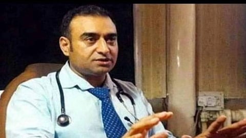 Image of Dr. Nisar ul Hassan wearing a stethoscope and speaking something.