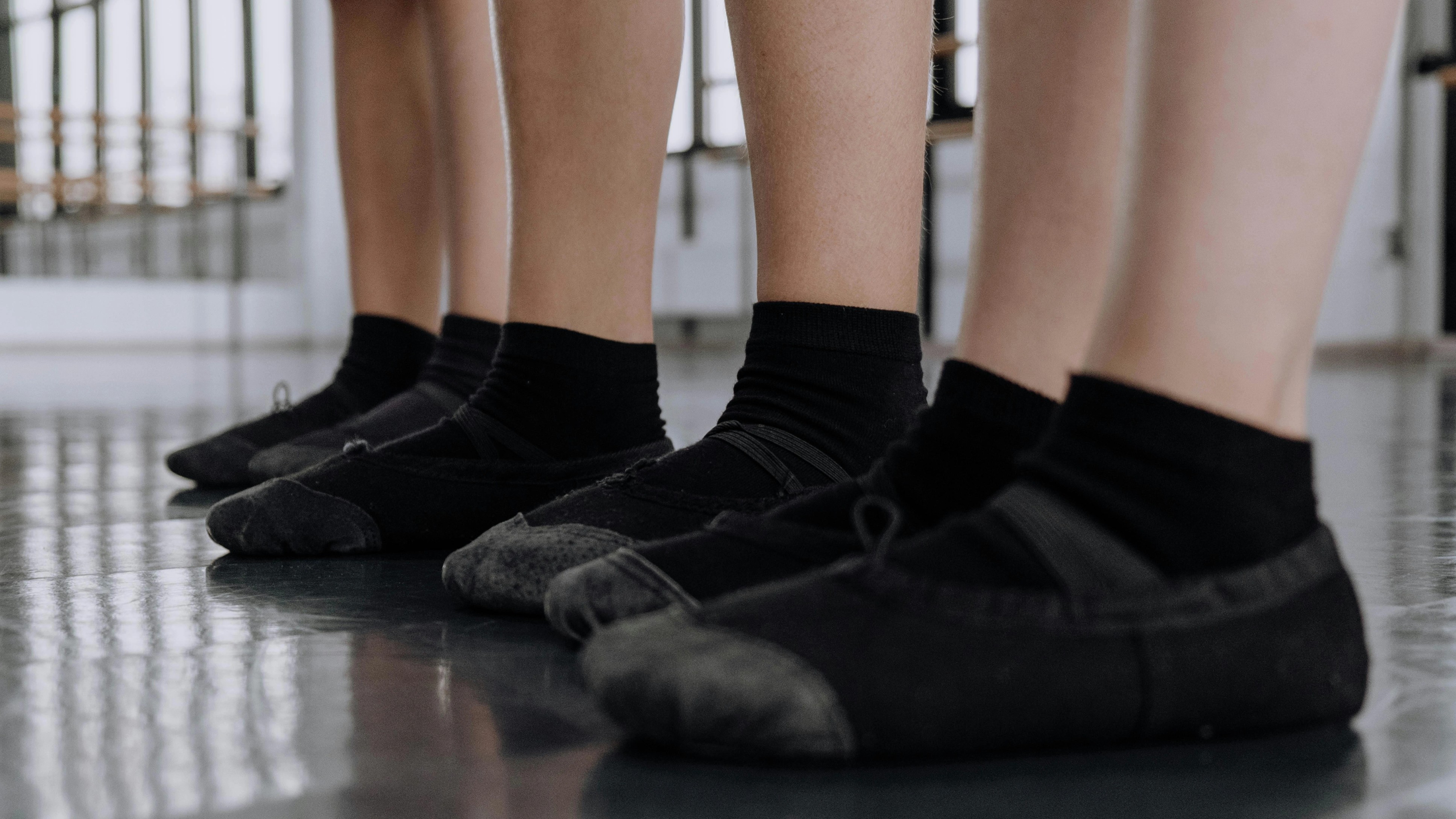 Image of a women wearing black sandals for a line dance.