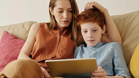 An image of a other and child with tab.