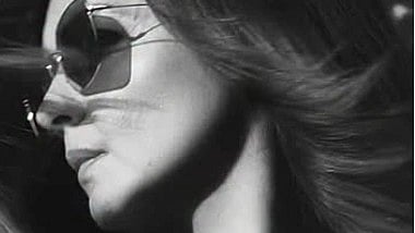 Black and white image of Pooja Bhatt wearing sunglasses.