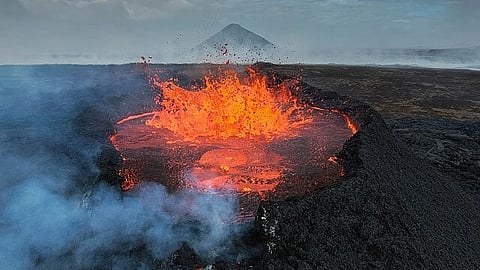 A volcanic eruption emitting fumes, lava and smoke. 