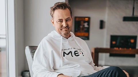 An image of Mathew Perry in a white sweatshirt.
