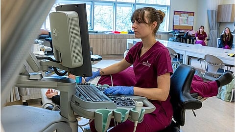 An image of a healthcare staff performing sonography.