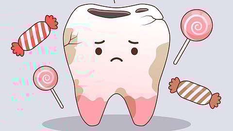 An image of cavity and cracks, surrounded by candy and lollipops