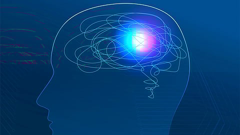 An image of a luminous brain in darkness having blue color background.