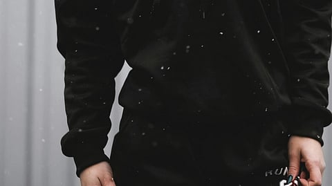 Image of a person wearing a black colored hoodie.