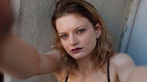 An image of a woman wearing a black dress and red lipstick.