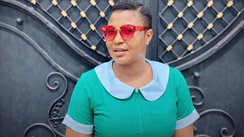 An image if Nurse from Ghana in a green and white uniform.