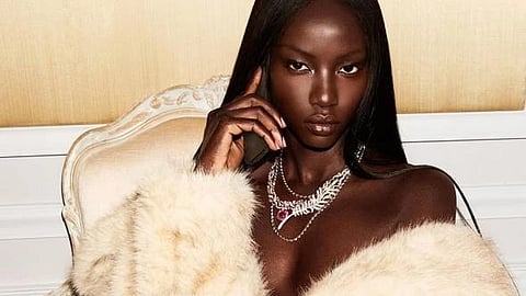 An image of Anok Yai in an off white fur coat. 