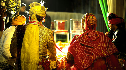 An image of a couple getting married in the Indian way.