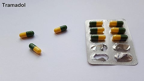A strip of Tramadol capsules with few laid out outside.