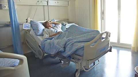 An image of a woman in a hospital bed.