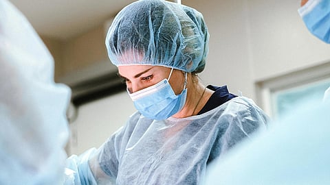 An image of 2 surgeons into a surgical theatre.