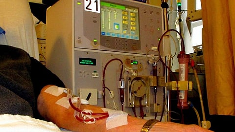 A dialysis unit and a close-up of a patient's hand 