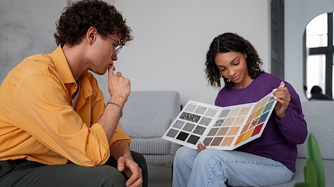 An image of man and woman examining a color palette.