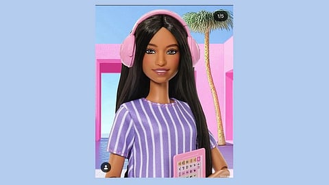 Barbie doll in stripped purple shirt, wearing headphones, holding communicator and blue background.